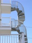 The only access to the apartment is the exterior spiral staircase